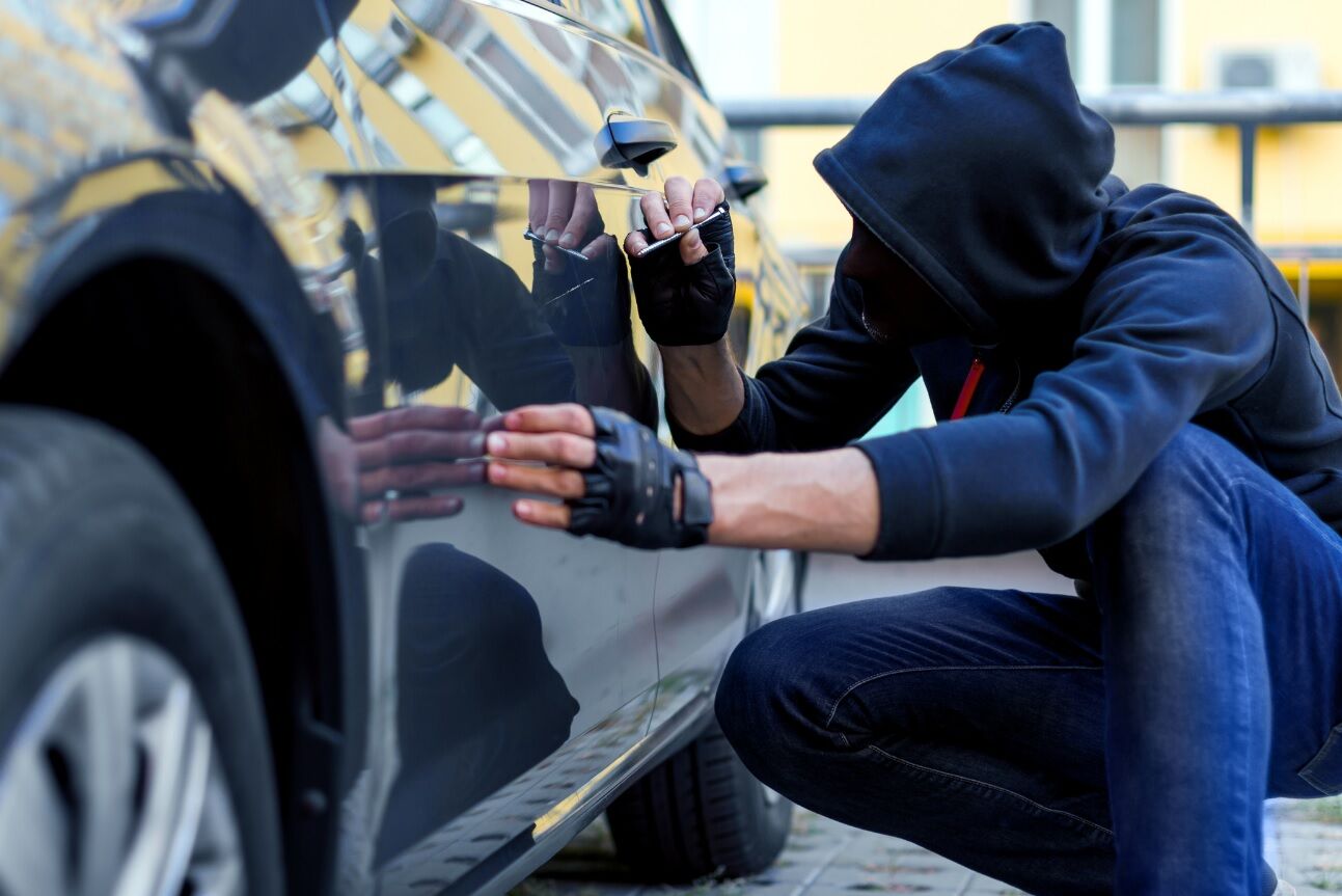 Person vandalizing a car